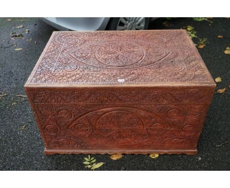 A carved trunk having brass handles.This lot can only be collected on Saturday 19th December (9-2pm).