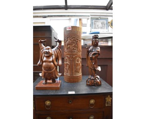 A Chinese carved wood figure of Guanyin,&nbsp;30cm high;&nbsp;together with a carved bamboo vase, 36cm high; and another carv