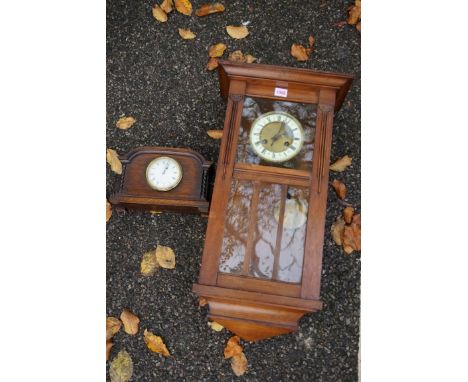 A mahogany hanging wall clock; together with an oak mantel clock.&nbsp;This lot can only be collected on Saturday 19th Decemb