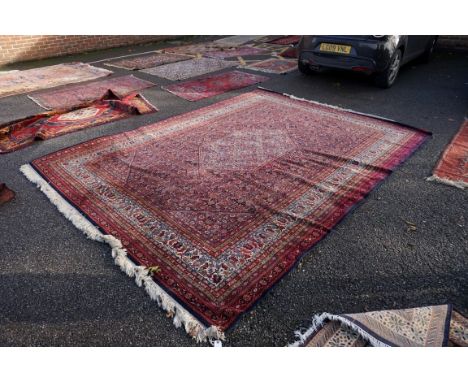 A Persian style carpet,&nbsp;having allover floral decoration to central field, with geometric and floral borders, 360 x 272c