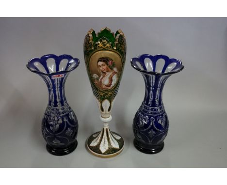 A late 19th century Bohemian green and white overlaid glass vase,&nbsp;painted with a panel of a lady, 35cm high; together wi
