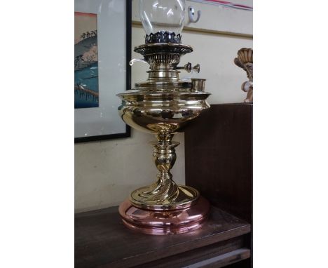 A brass and copper oil lamp,&nbsp;height excluding chimney 35cm.&nbsp; 