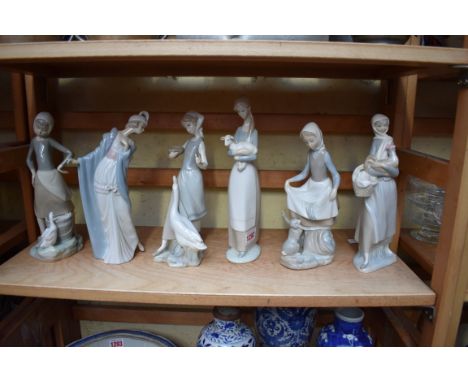 Six Lladro figures, largest 26.5cm high, (chip to index finger of one). 