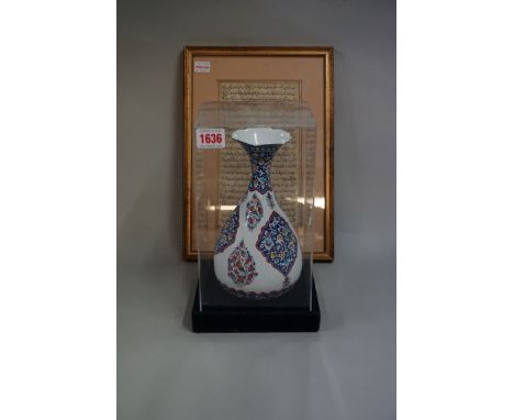 A Persian enamel baluster vase,&nbsp;22.5cm high; together with an Islamic manuscript page, 22 x 12.5cm, framed and glazed. 
