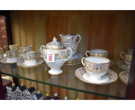 A Wedgwood 'Gold Florentine' pattern part tea service, comprising: sucrier &amp; cover; sugar bowl; milk jug; six side plates