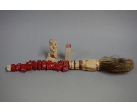 A Chinese bone and coral calligraphy brush,&nbsp;36cm long; together with an ivory seal, 5.7cm long; and a Japanese okimono, 