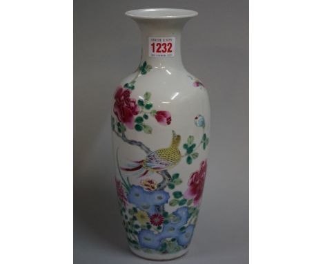 A Chinese famille rose vase, probably late 19th century, painted with a bird and butterfly amongst flowering branches, 29cm h