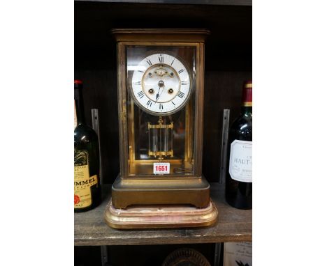 A late 19th century gilt brass four glass mantel clock,&nbsp;33cm high, with mercury pendulum and winding key, on giltwood st