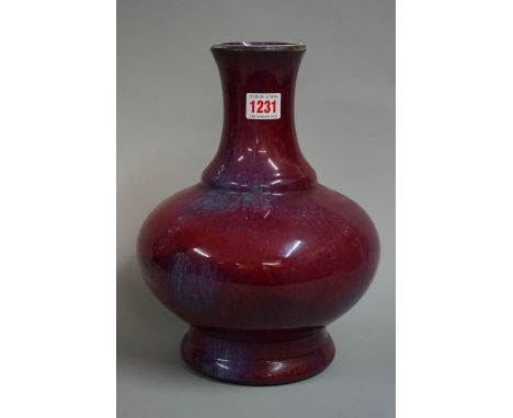 A Chinese sang de boeuf baluster vase, Qing, with flambe glaze, 29cm high, (s.d.). 