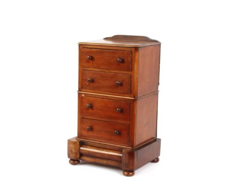 A mahogany trinket cabinet, fitted four short drawers and blind base drawer, raised on an inverted platform and bun feet, 27c