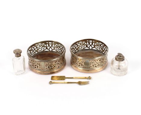 A pair of plated coasters, with turned wooden handles; a silver topped toilet jar; a silver topped powder jar with integral b