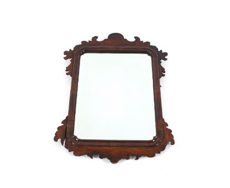 A mahogany framed wall mirror, in the Chippendale manner, having fret carved frieze and cushion surround, 74cm x 50cm in extr