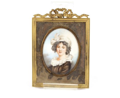 A 19th Century miniature portrait study, of a young girl wearing mop cap, in gilt easel frame with ribbon tied surmount