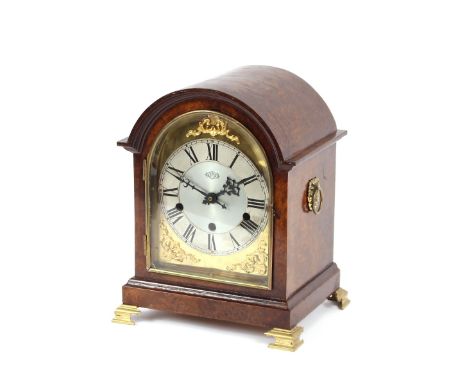 A walnut cased chiming mantel clock, by Garrard, raised on gilt bracket supports, 29cm high