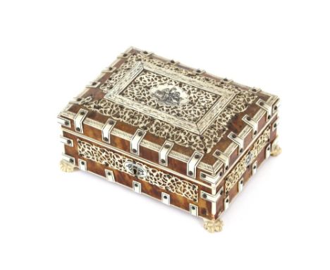 An Indian tortoise shell and ivory inlaid trinket box, the hinged lid decorated with a central seated figure amongst pierced 