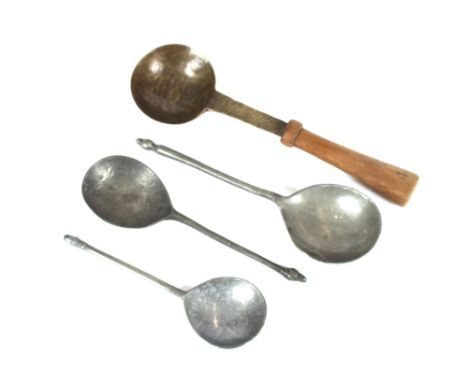 A collection of three pewter spoons, in the 17th Century style with acorn finials; and another Antique ladle with wooden hand