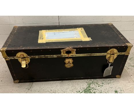 A steamer trunk with blue and brass band 