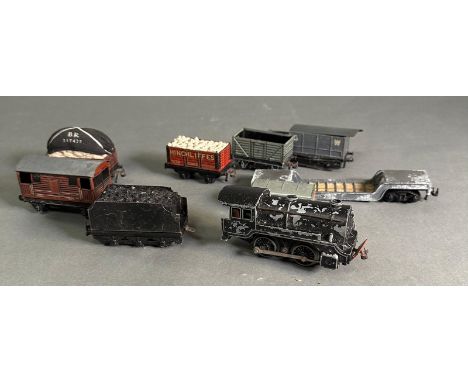 A selection of tin plate rolling stock and an engine 