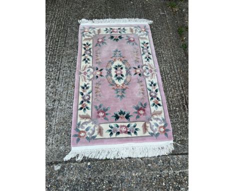 A light pink rectangle wool rug with floral boarder and central medallion 170cm x 192cm Condition Report good condition will 