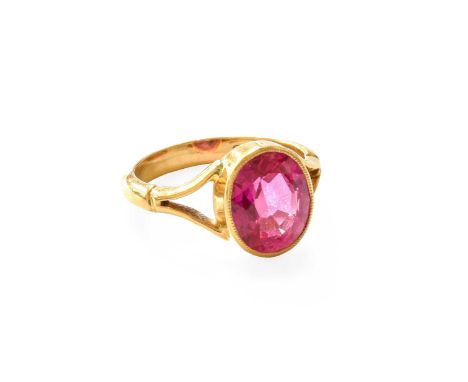 A 22 Carat Gold Synthetic Ruby Ring, the oval synthetic ruby in a yellow millegrain setting, to a forked shoulder plain polis