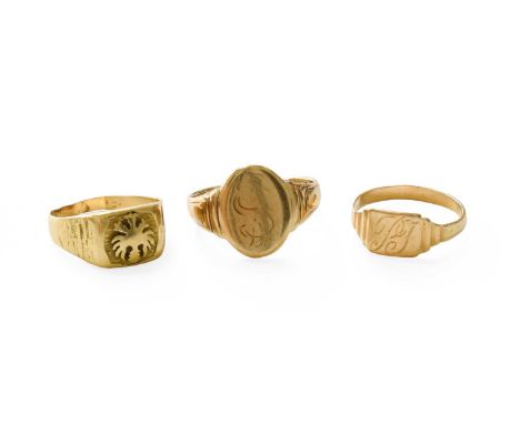 A 9 Carat Gold Signet Ring, out of shape; A Signet Ring, stamped 'C18', finger size M; and Another, one out of shape9 carat g