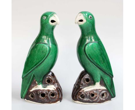 A Pair of Chinese Porcelain Models of Parrots, Kangxi style, green glazed and on pierced rockwork bases, 20cm (2)Good conditi