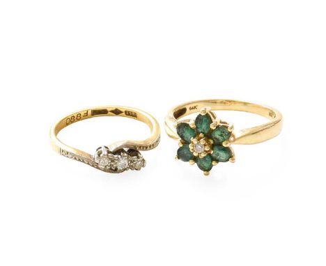 A Diamond Three Stone Twist Ring, stamped '18CT' and 'PLAT', finger size L; An Emerald and Diamond Cluster Ring, stamped '14K