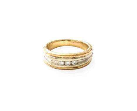 A Bi-Colour 9 Carat Gold Diamond Three Stone Ring, the round brilliant cut diamonds in a white channel setting, to a yellow p