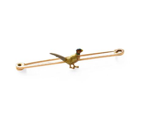 An Enamel Pheasant Brooch, the yellow tapered bar with a textured pheasant motif centrally, the head enamelled in red, yellow