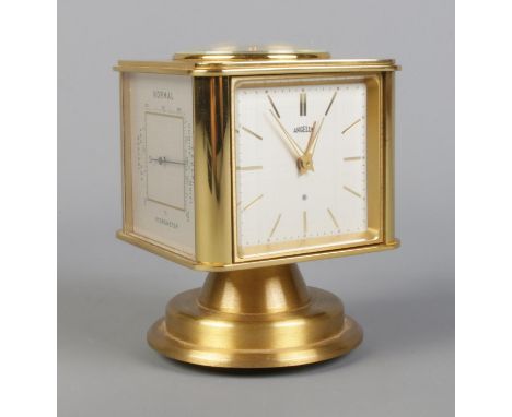 A vintage brass Angelus desk clock/weather station. Having rotating cube shaped body with alarm clock, Hygrometer, Barometer,