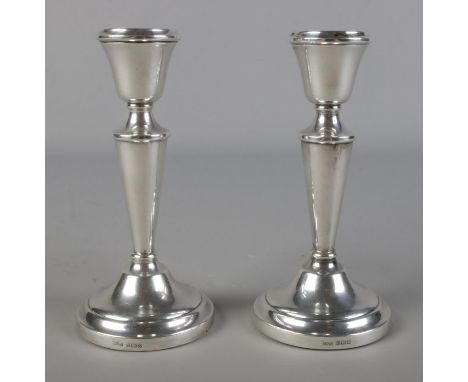 A pair of silver filled candlesticks. Birmingham 1972 J M-A, 318g.Hx14cm  Light tarnishing to tops. Small dents to one exampl