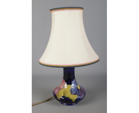 A Moorcroft blue ground Clematis pattern ceramic lamp shade. Approx. height without shade 20cm.  
