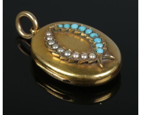 A Victorian gold locket with seed pearl and turquoise set laurel decoration. 11.04g. Tests as 15ct. 3cm x 2.2cm.  