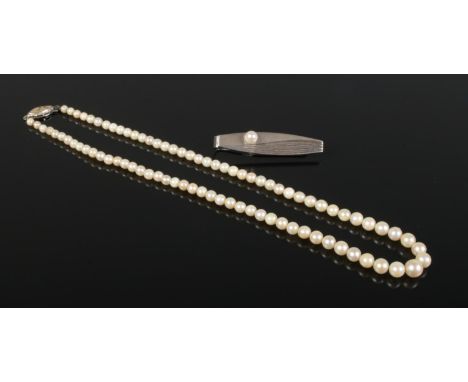 A silver Mikimoto Tokyo tie slide, together with a string of cultured pearls.  