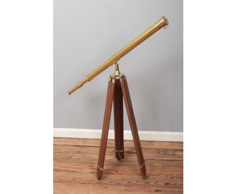 A brass 19th century style telescope on brass mounted tripod.  