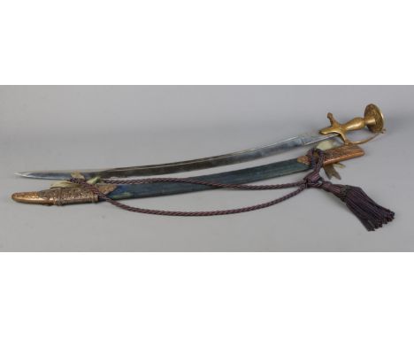 An Indian Tulwar sword with engraved brass handle. The sheath bearing presentation inscription for Brigadier WNJ Withall from