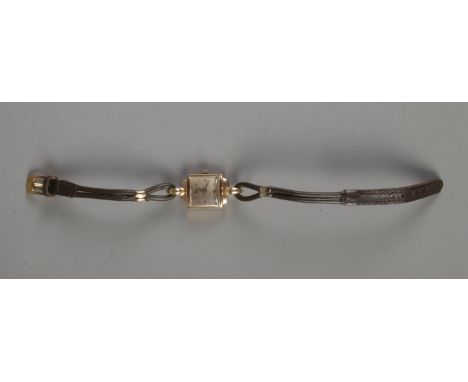 A ladies 9ct gold cased cocktail watch on leather strap.  Light scratching to glass.