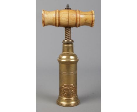 A Thomason type patent brass corkscrew with turned bone handle. Bearing coat of arms inscribed Ne Plus Ultra.  