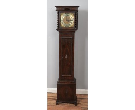 A John Mason of Rotherham oak longcase clock decorated with cherub scrollwork motifs and roman numeral dial. Movement stamped