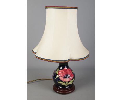 A Moorcroft blue ground anemone pattern table lamp with shade. Approx. height without shade 20cm.  