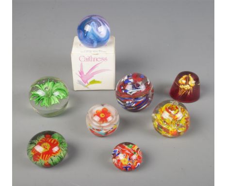 A collection of glass paper weights with one resin example and one boxed Caithness paperweight  