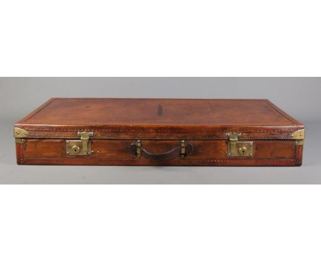 An early 20th century French Moynat leather and metal bound flat travel trunk. Height 13cm, Width 87cm, Depth 44cm.  