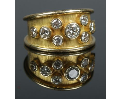 An 18ct gold and nine stone diamond ring. Total diamond weight approximately 1.2ct. Size R 1/2. 10.42g. Stamped 750.  Stones 