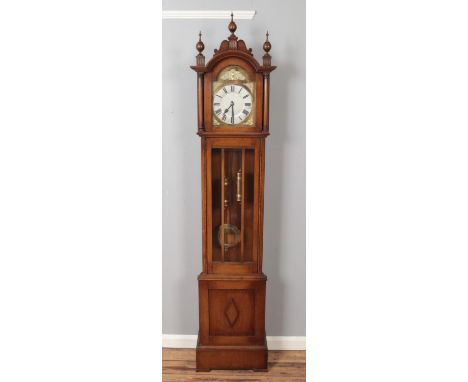 A carved oak longcase clock with turned finials. (211cm x 45cm)  