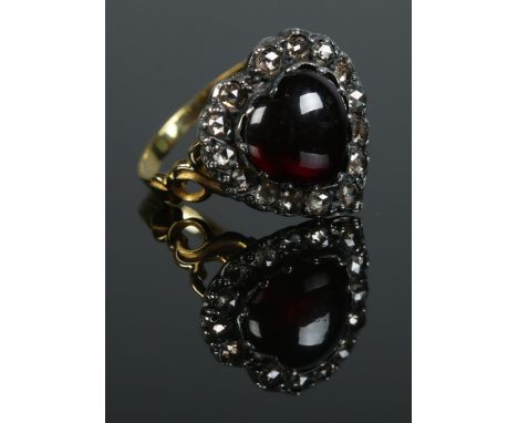 A gold dress ring of heart shape, with central cabochon garnet and diamond surround. Size N 1/2. 4.19g.  