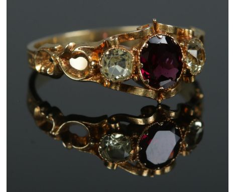 An early to mid 19th century 18ct gold garnet and chrysoberyl three stone ring. Size R. 2.51g.  