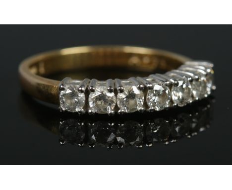 An 18ct gold seven stone diamond ring. Size M 1/2. 3.56g. Approximately diamond 0.75ct in total.  