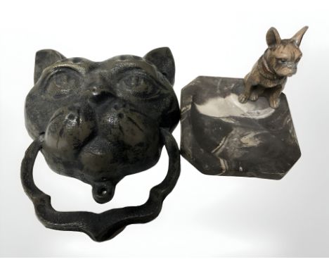 A ceramic ash tray surmounted by a cold painted metal figure of a dog, together with a cast iron door knocker in the form of 