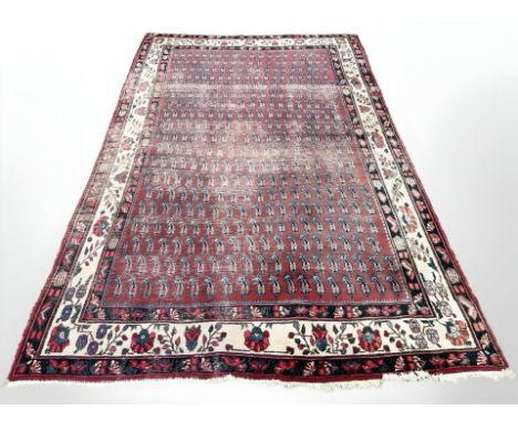 A Kashan carpet, West Iran, with all over repeat boteh motif, 304cm by 203cm   CONDITION REPORT:  Well worn.