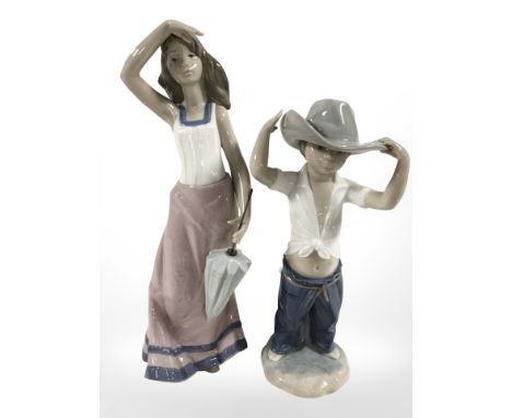 A Nao figure of a girl holding a parasol, No. 1294, and a further figure of a boy wearing a cowboy hat, tallest 31 cm.